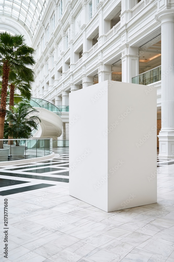 Naklejka premium Empty white pedestal in bright modern hotel atrium