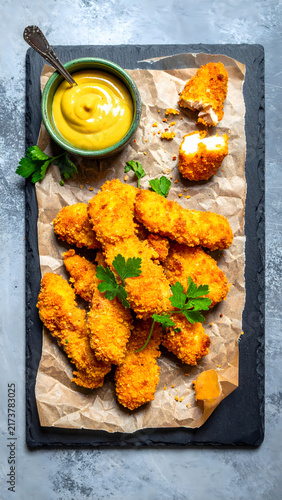Crispy Chicken Tenders with Mustard Sauce on Slate Board, Top View