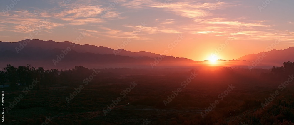 Obraz premium sunrise over misty mountains and valley landscape