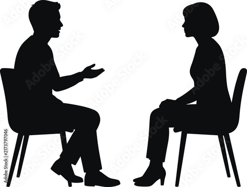 Black silhouette of man and woman sitting on chairs engaged in deep professional corporate conversation