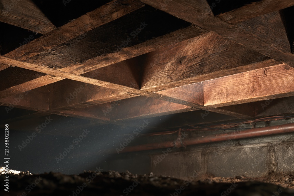 Fototapeta premium Old wooden beams with light in dark basement