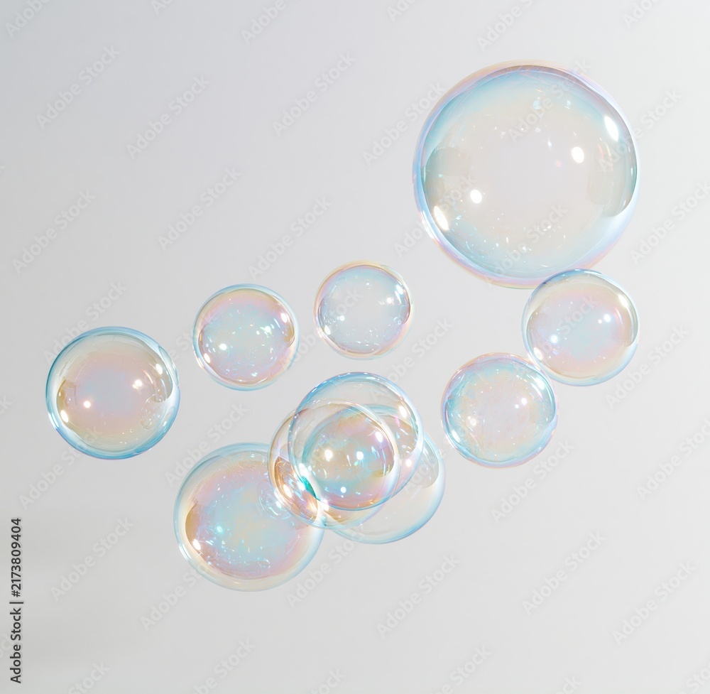 Obraz premium Colorful soap bubbles floating against white background