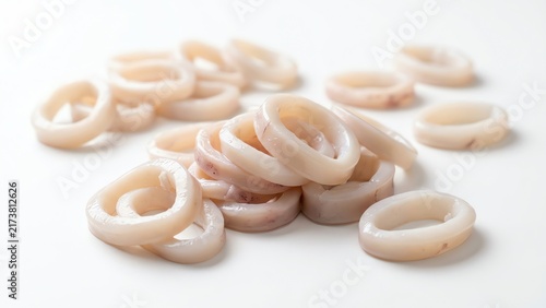 Fresh raw squid rings piled on white background