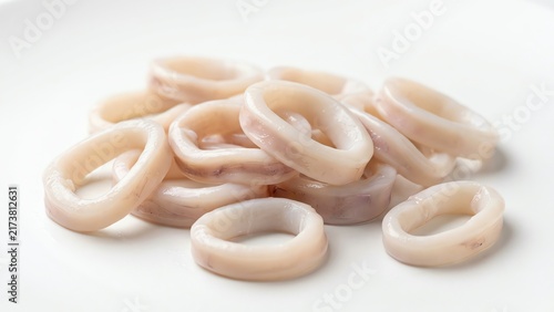 Raw sliced calamari squid rings on a white background