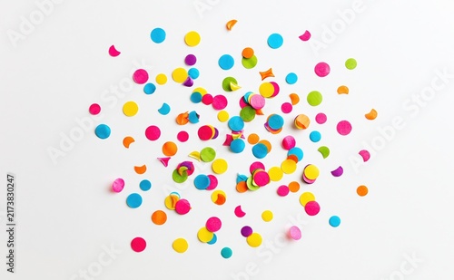 Colorful confetti scattered on white background