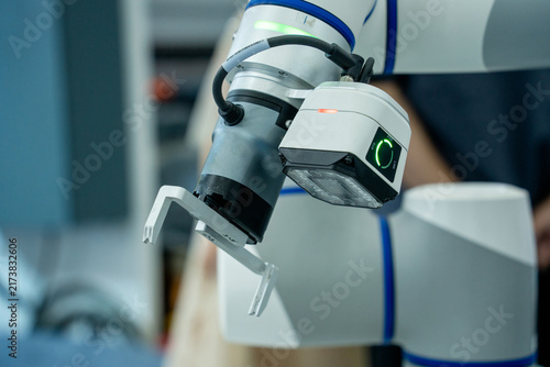 Obraz na płótnie Robotic arm with gripper and sensor in workspace
