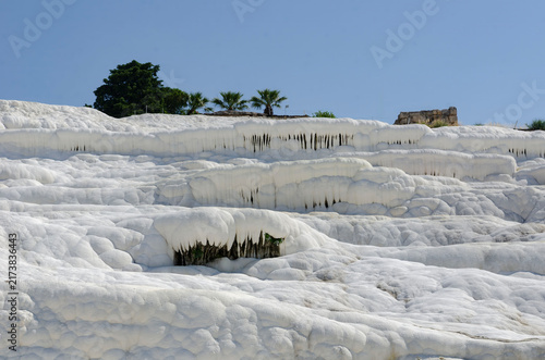 Pamukkale Turkey travertine terraces white mineral formations thermal springs ancient landscape blue sky natural wonder tourism destination geology calcium pools