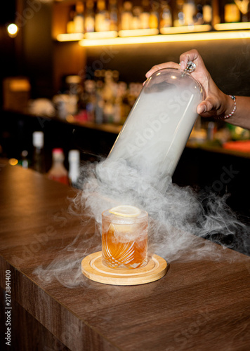 Bartender Pouring Liquid Nitrogen into Cocktail Glass.