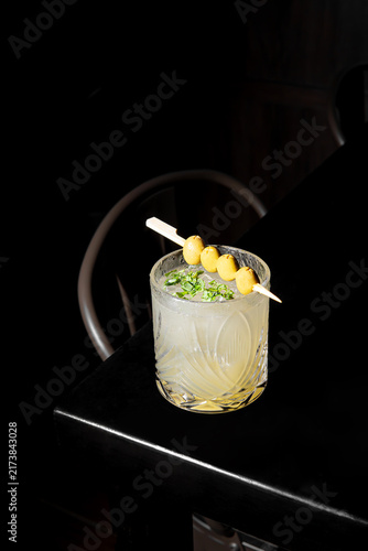 Elegant Cocktail with Pineapple Garnish on Dark Background.