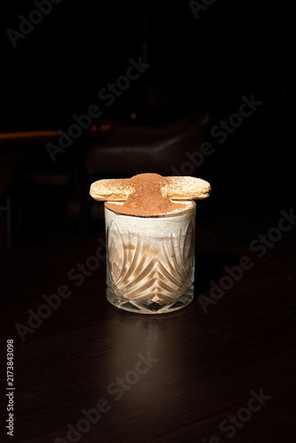 Elegant dessert in glass with biscuit topping.