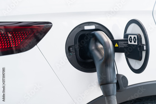 4K slow motion person charging electric car at Charger station.	
