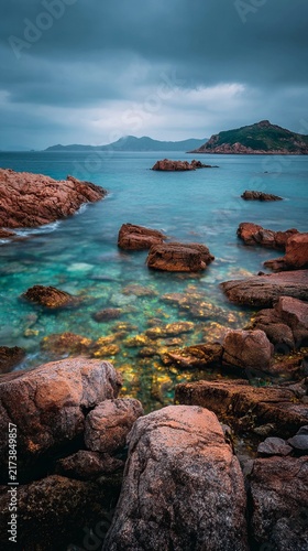 Rocky Shoreline Serenity - A Coastal Landscape with Turquoise Waters.