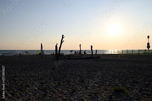 People enjoying sundown at tuscany beach. Togetherness at italian beach. Marina di Torre del LAgo, Tuscany, Italy, Europe.