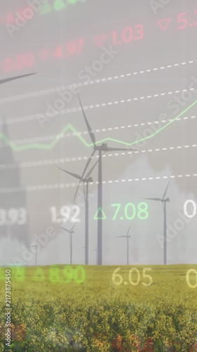 Animation of stock market data processing against spinning windmills on grassland