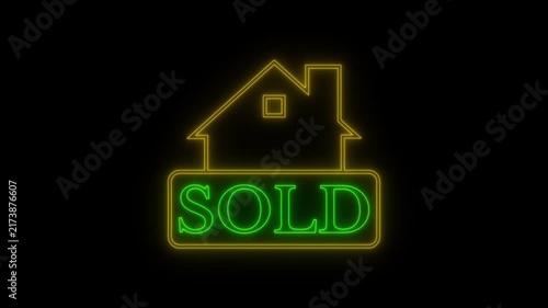 Neon house sold sign glowing on black background.