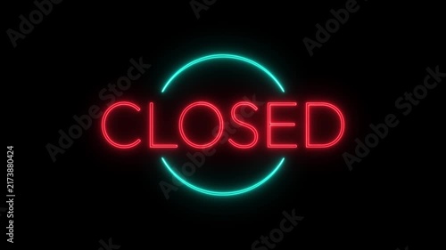 Neon closed sign flickering with blue circular border on black wall.