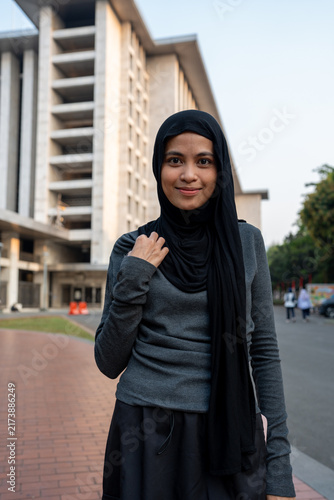 Fotografie Muslim woman smiling wearing hijab outside mosque