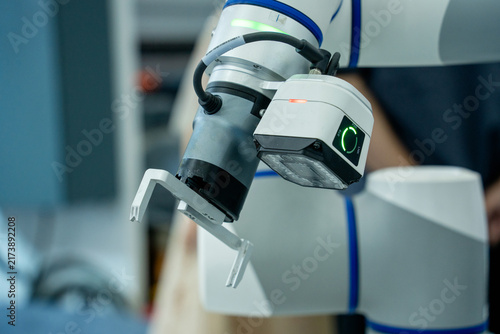 Obraz na płótnie Robotic arm with gripper and sensor in workspace