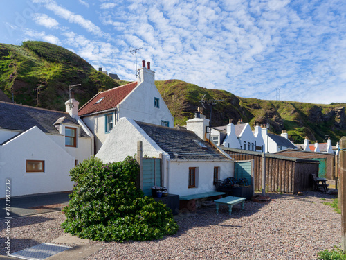 Obraz na płótnie Houses and Cottages of different sizes in Pennan near the small Harbour along the Main Street on a sunny Morning in Late August