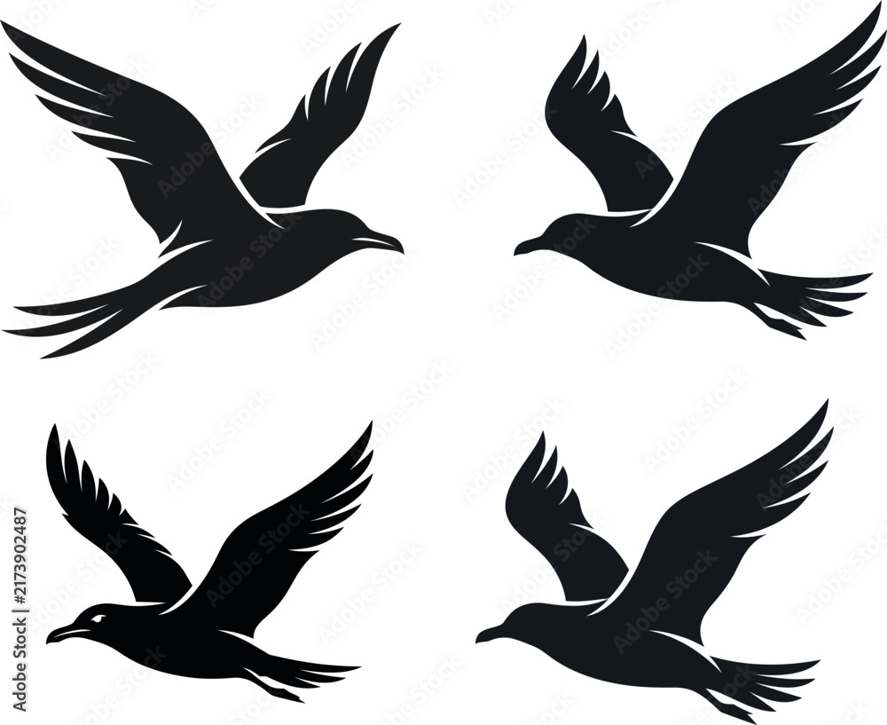 Obraz premium Set of four black bird silhouettes flying in various poses isolated on white background
