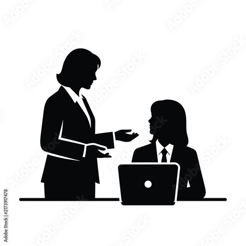 Two businesswomen collaborating in an office setting.
