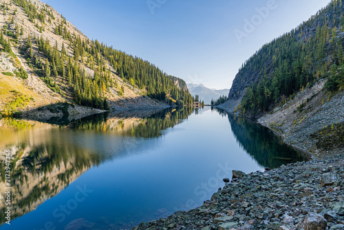 Calm reflection on Lake Agnes surrounded by autumn mountains, Banff, Canada