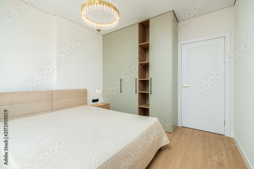 Картината върху платно Sage green built-in wardrobe with open wooden shelving unit