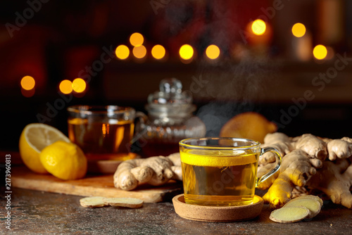 Photography Cup of ginger tea with lemon, honey, mint, and ginger root.