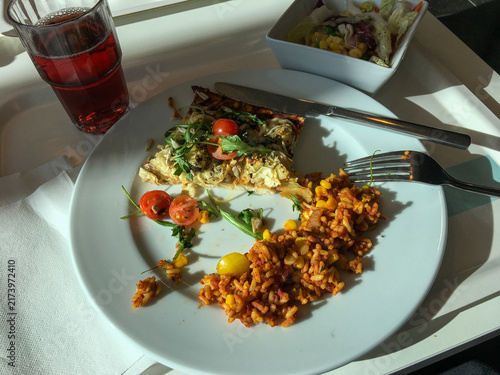 Vegetarian lunch plate with pizza slice, rice and salad
