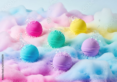 Colorful bath bombs sit atop a textured landscape of pastel soap foam and effervescent bubbles, creating a bright and relaxing spa scene, refreshing, colorful, organic
