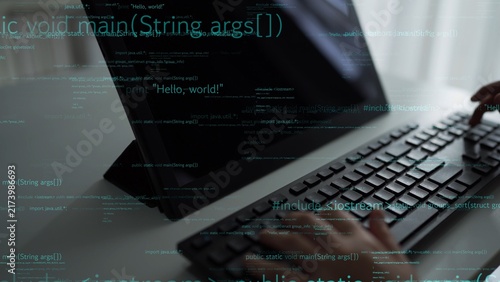 фотографія A focused programmer types code on a sleek keyboard while reviewing programming syntax on a monitor, emphasizing the essence of software development and technology
