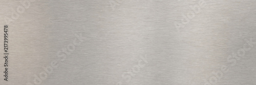 Brushed metal texture with horizontal grain, silver stainless steel surface background, industrial aluminum metallic finish, sleek grey plate for modern architectural design and tech