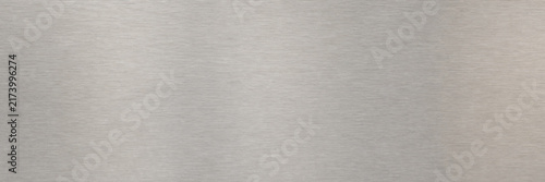 Brushed metal texture background, silver stainless steel surface with horizontal grain, industrial metallic aluminum plate for tech design, sleek gray chrome finish for modern backdrop.