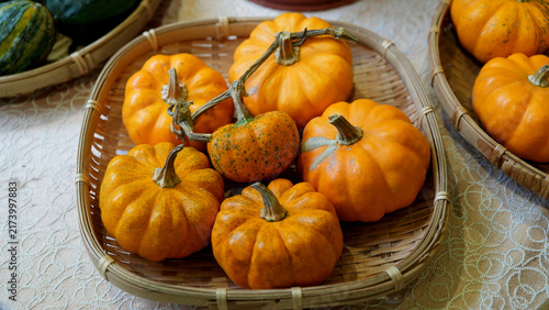 Orange Mini Pumpkins in a Bamboo Basket