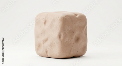 Handmade beige clay cube with fingerprint textures on white background