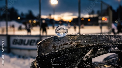 Closeup of water droplet on boat surface during sunset