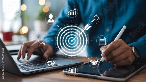 Professional Businessman Using Digital Tablet and Laptop for Strategic Business Goal Setting and Target Achievement