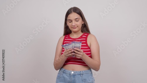 Happy Indian Teenage Girl Counting 100 Indian Rupee Notes