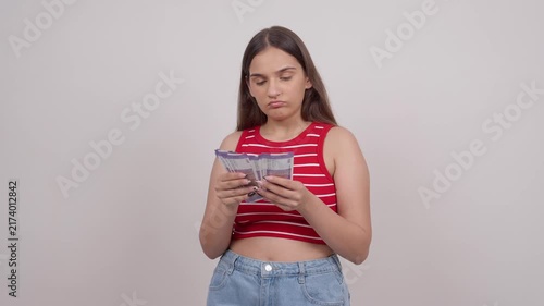 Confused Indian Teenage Girl Counting 100 Indian Rupee Notes