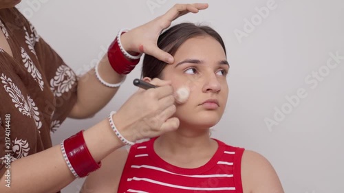 Makeup Artist Using Makeup Brush on Indian Teenage Girl 