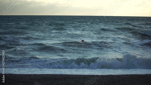 Ocean, Waves, Person - A lone person stands on a beach watching waves crash in the ocean.