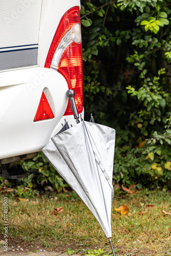 Konstfotografi Helsingborg, Sweden An umbrella is propped against an RV camping vehicle in case of rain