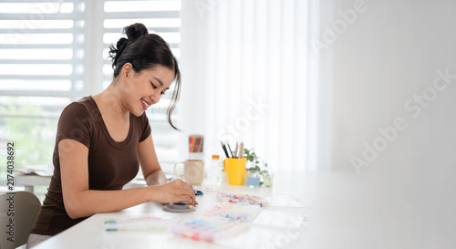 Canvas Print Woman at home spends time on hobby Stringing beads
