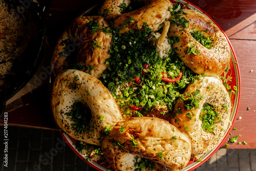 Top view of tandoor flatbreads on traditional pilaf platter