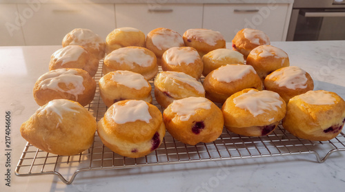 Artisanal homemade berliner donuts with sugar glaze on cooling rack