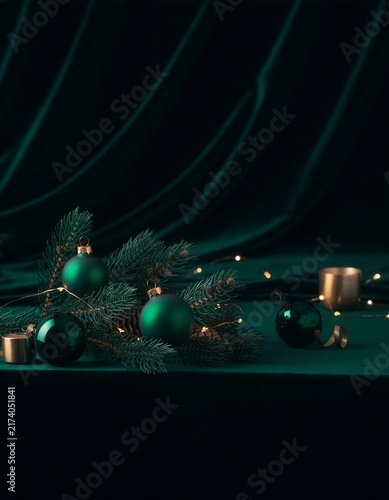 Elegant Green Christmas Ornaments and Pine Branches on Dark Emerald Background