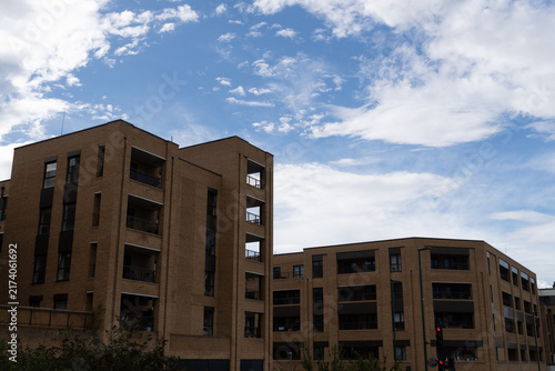 Canvas Print Modern Residential Buildings Under Dramatic Cloudy Sky During Daytime