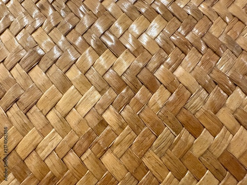 Close up of natural woven bamboo mat texture showing intricate craft patterns, ideal for background and traditional design concepts