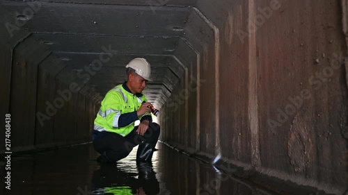 Maintenance Engineer Examining Underground Drainage System and Water Infrastructure