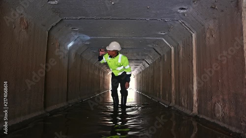 Maintenance Engineer Examining Underground Drainage System and Water Infrastructure